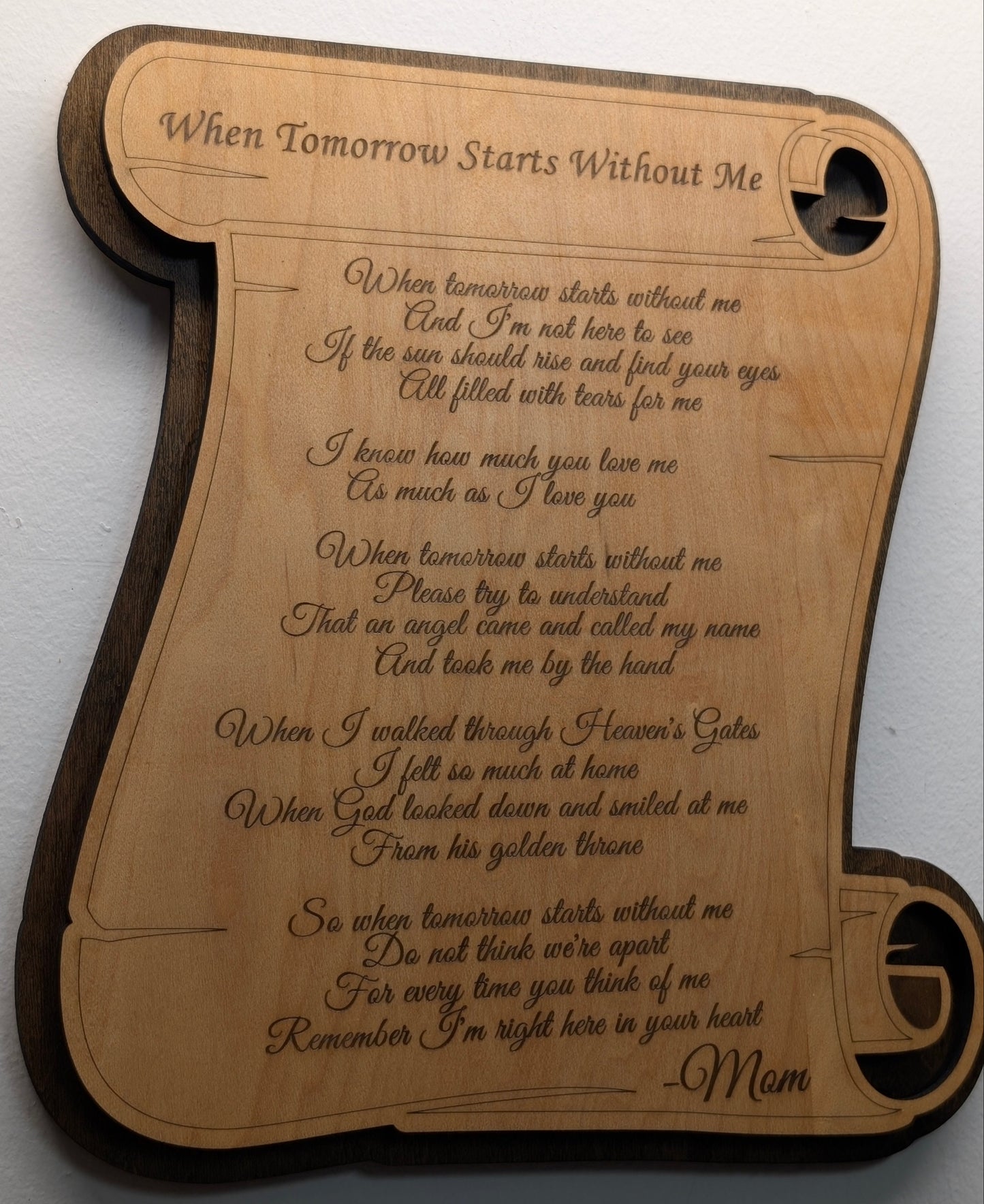 Wooden plaque with engraved poem on a white background