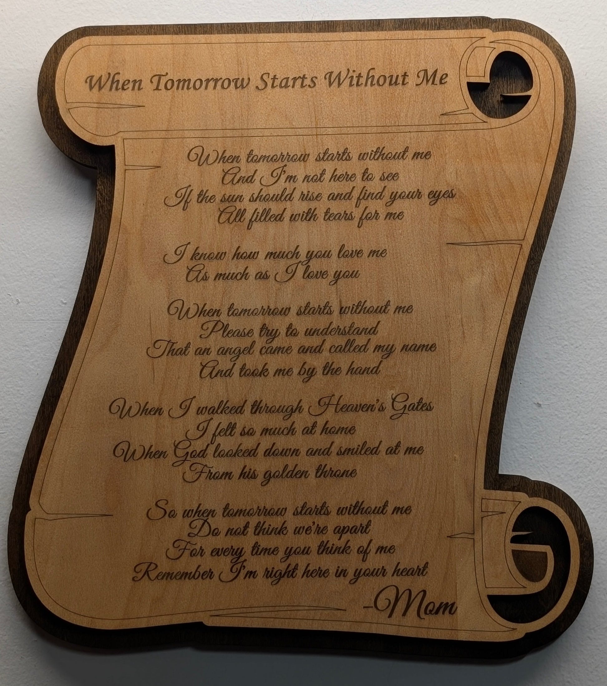 Wooden plaque with engraved text on a white background