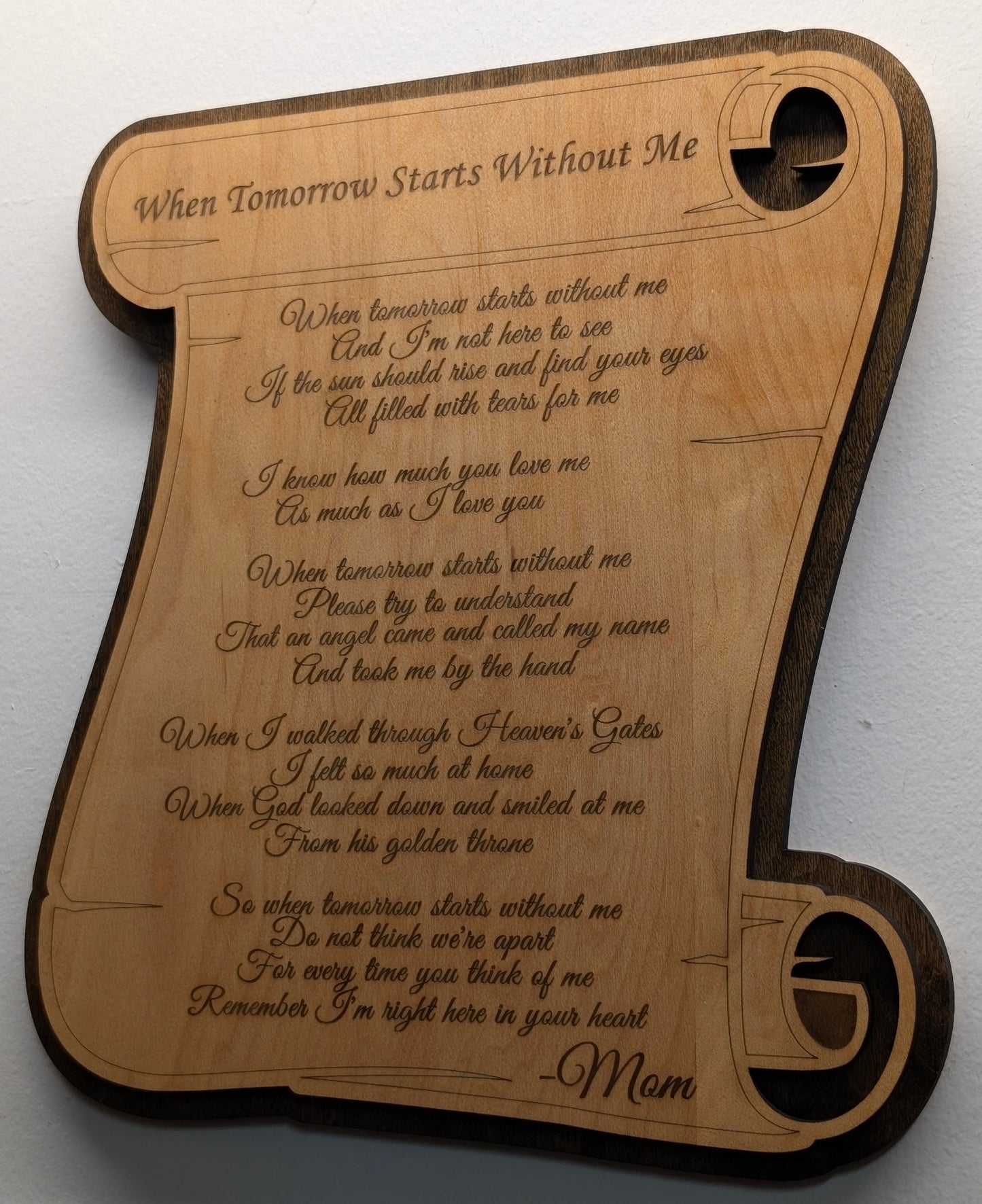 Wooden plaque with engraved text on a white background