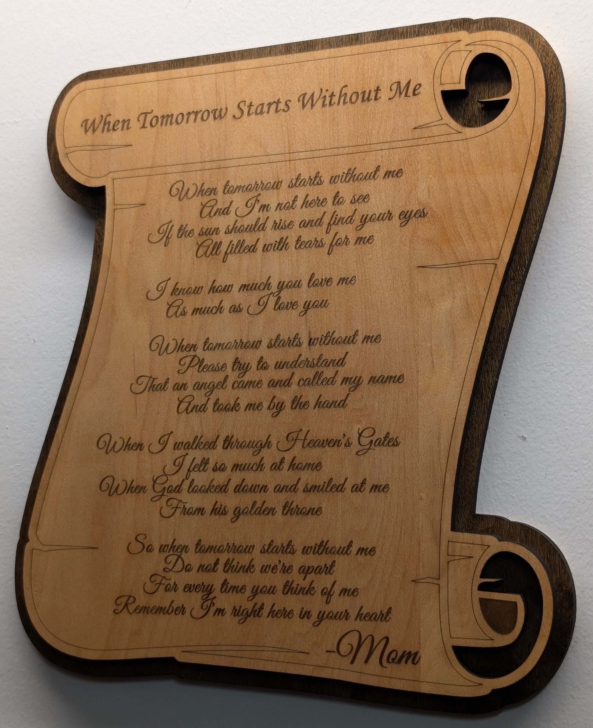 Wooden plaque with engraved text on a white background